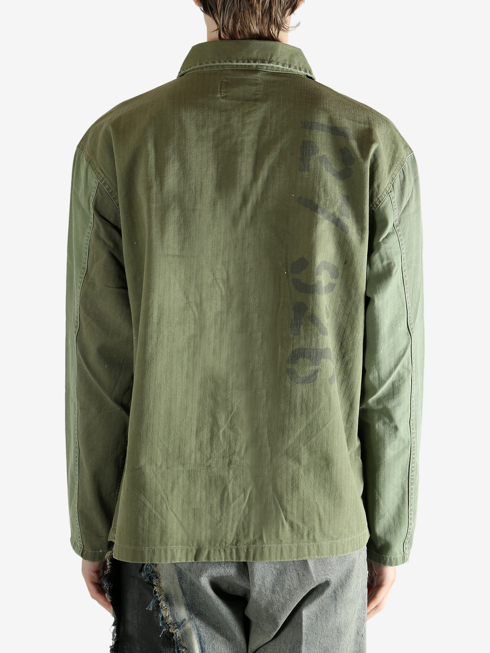 Green shirt worn by a person, showing the shirt's fit