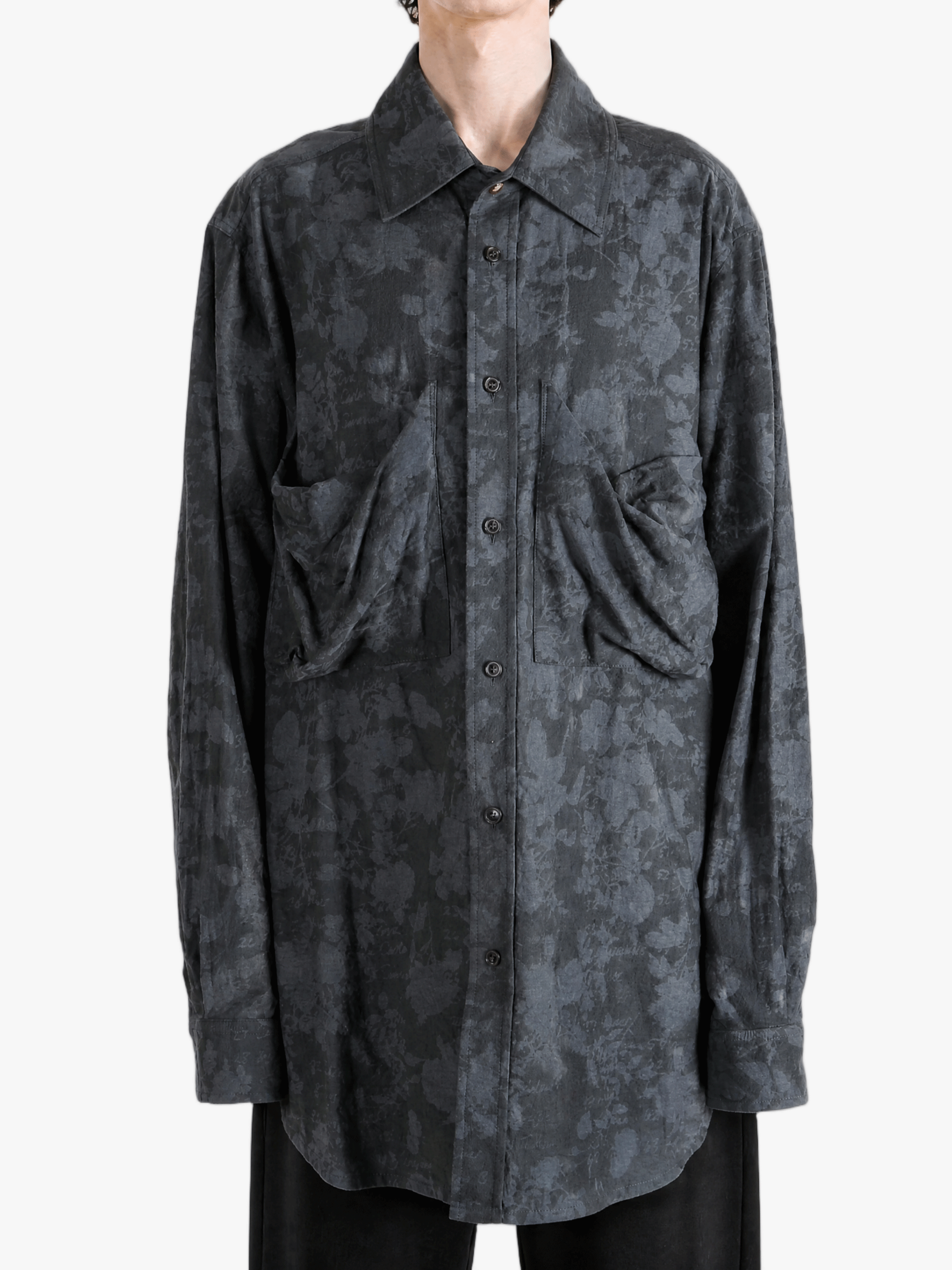 Grey shirt worn by a person, showing the shirt fit