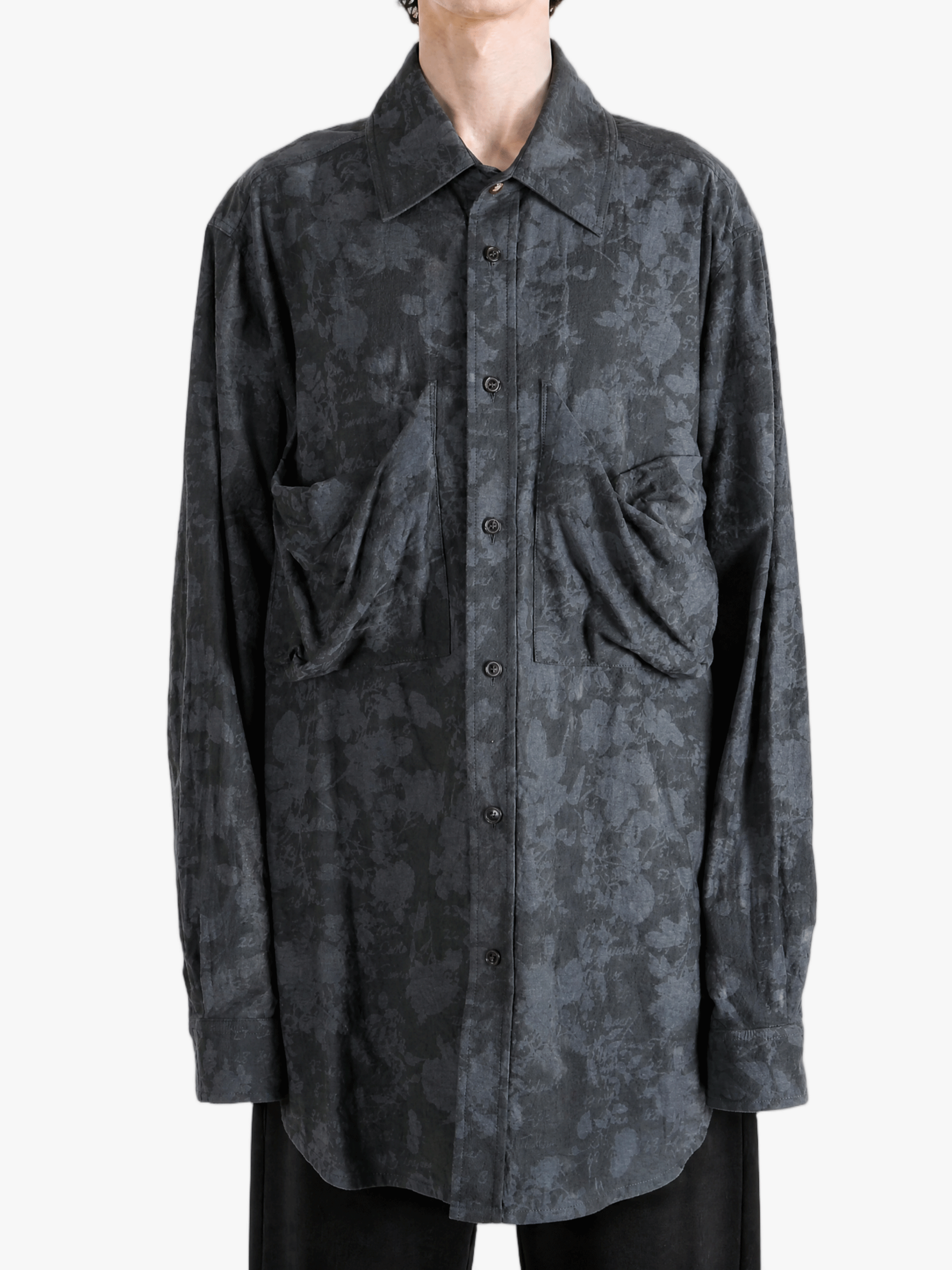 Grey shirt worn by a person, showing the shirt fit