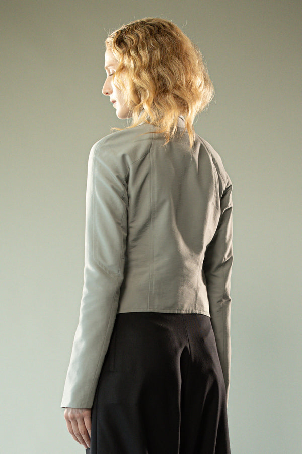 Grey jacket worn y a person, showing the jacket's fit