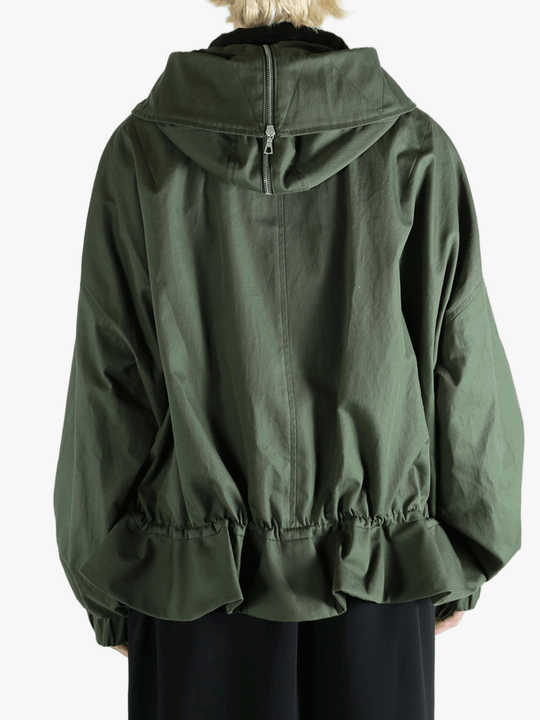 Green jacket worn by a person, showing the jacket's fit