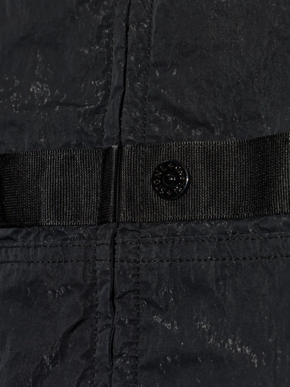 Close up of Black jacket, showing texture of the 100% polyamide fabric
