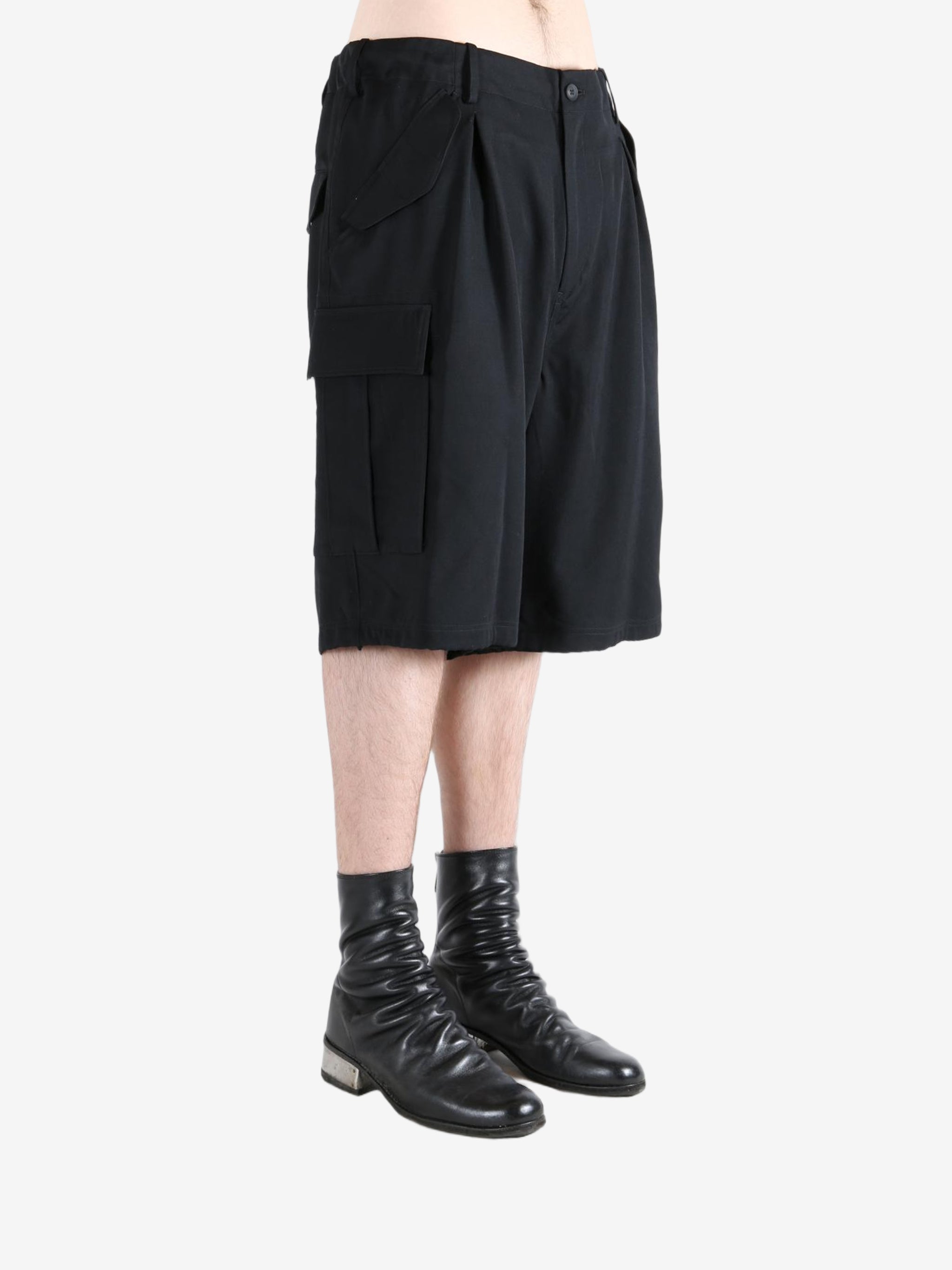 Black pants worn by a person, showing the pants's fit