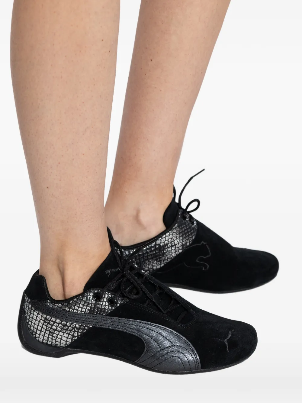 black sneakers worn by a person,showing the sneakers fit