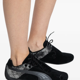 black sneakers worn by a person,showing the sneakers fit