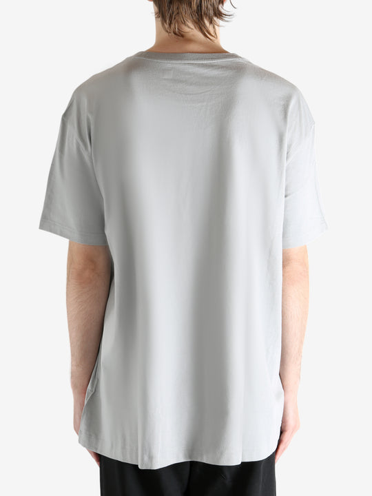 Grey t-shirts worn by a person, showing the t-shirts fit