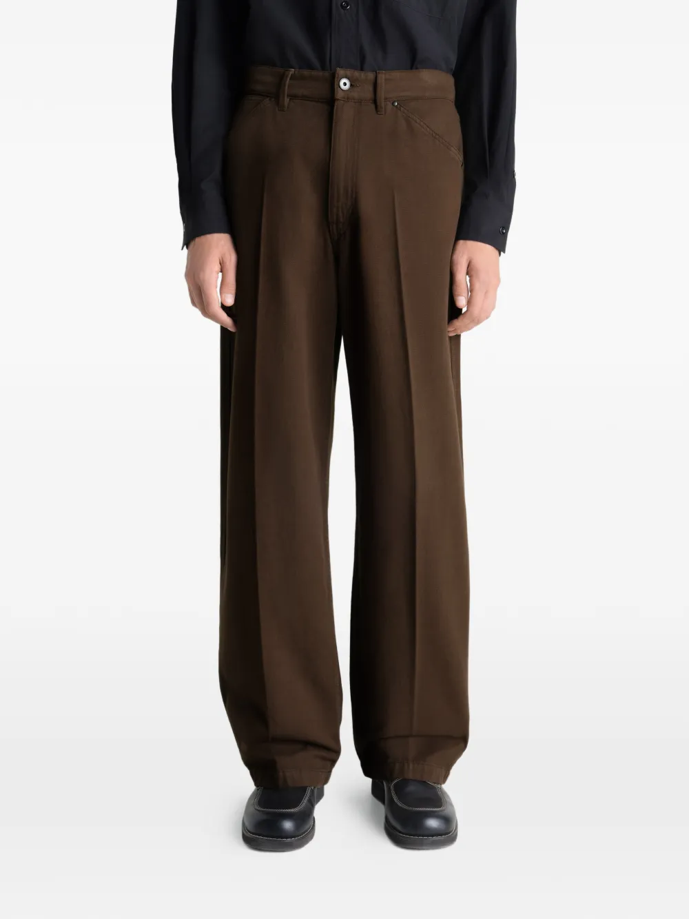 Brown pant worn by a person, showing the pant's fit