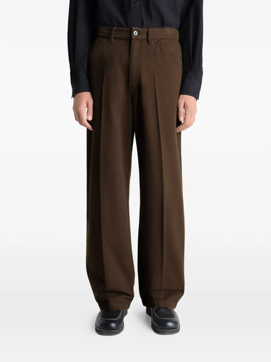 Brown pant worn by a person, showing the pant's fit