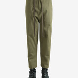 Green pants worn by a person, showing the pants's fit