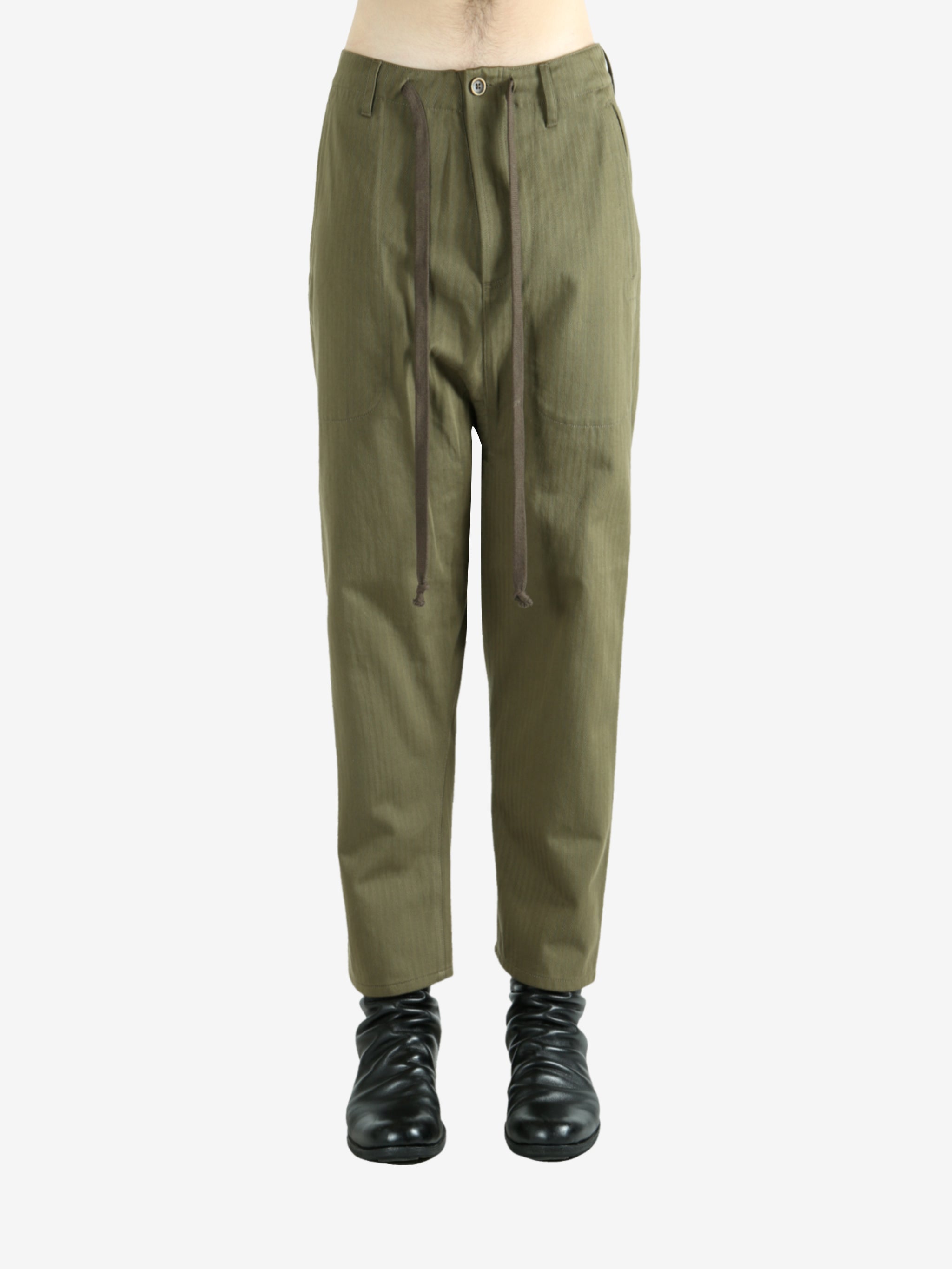 Green pants worn by a person, showing the pants's fit