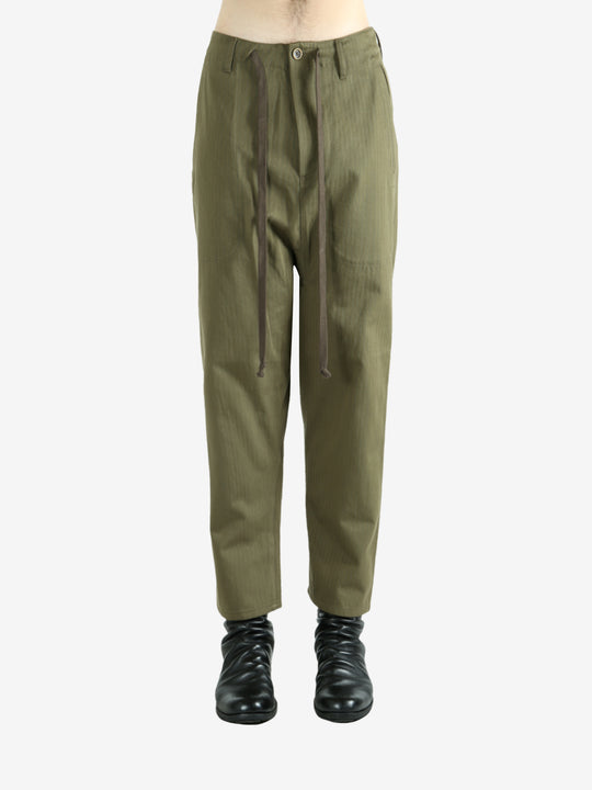 Green pants worn by a person, showing the pants's fit