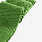Close up of the green scarf, showing texture of the wool fabric
