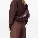 Brown bag carried by a person, showing the bag's size