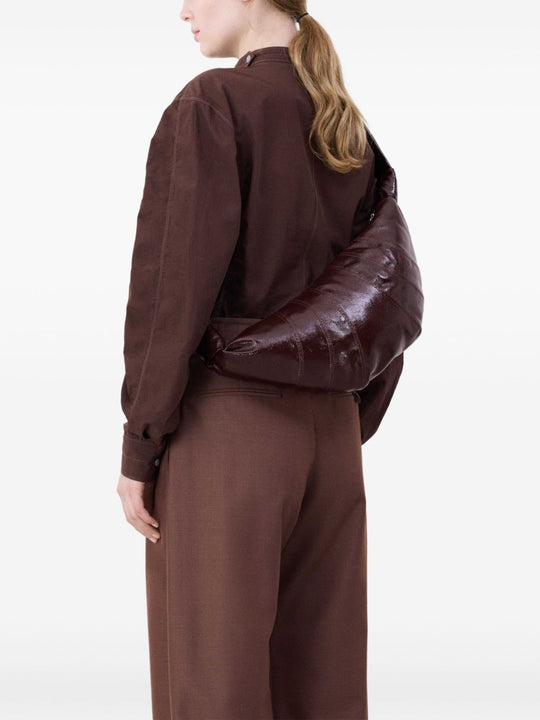 Brown bag carried by a person, showing the bag's size