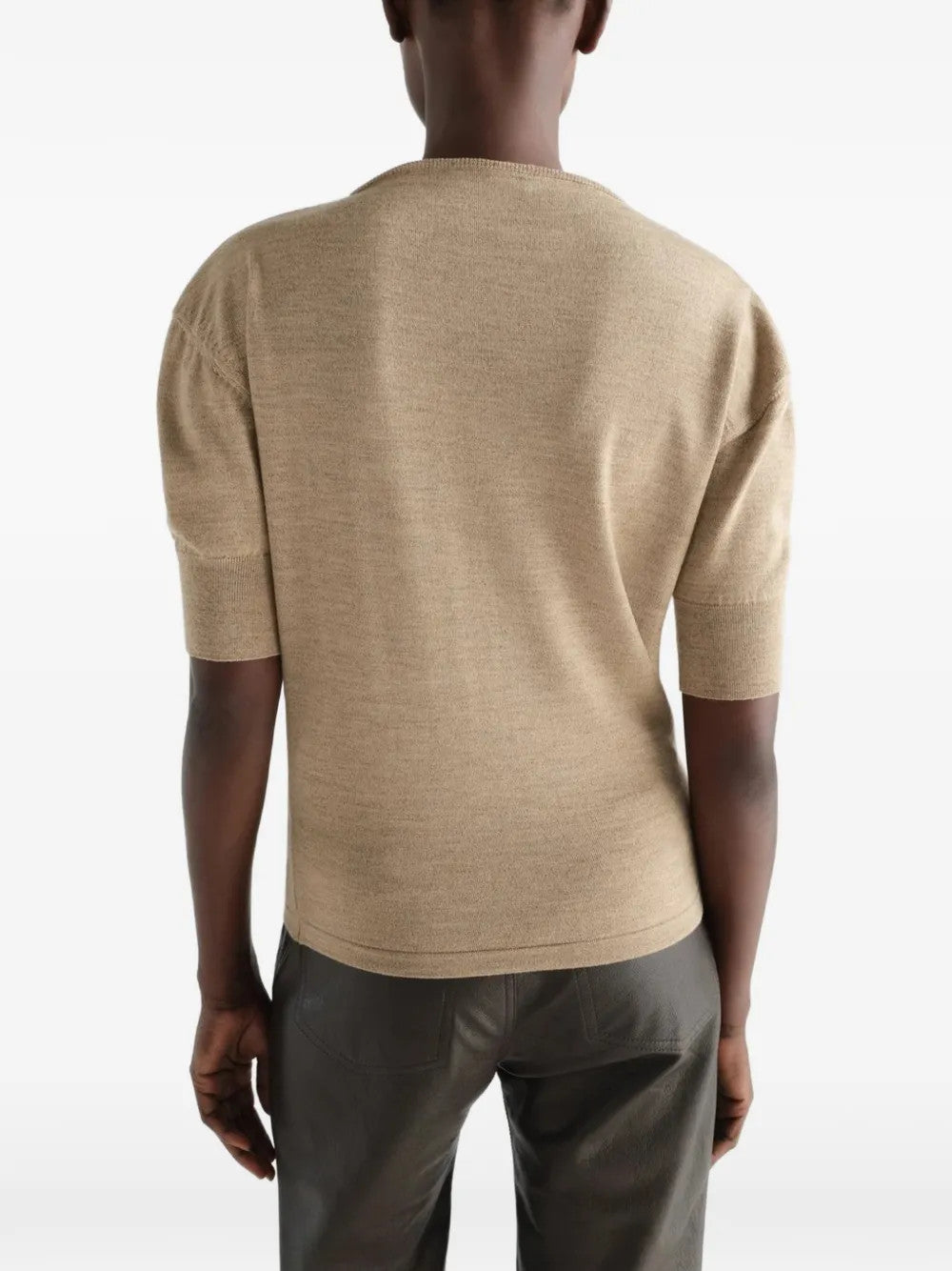 Tan knitwear worn by a person, showing the knitwear fit