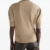 Tan knitwear worn by a person, showing the knitwear fit