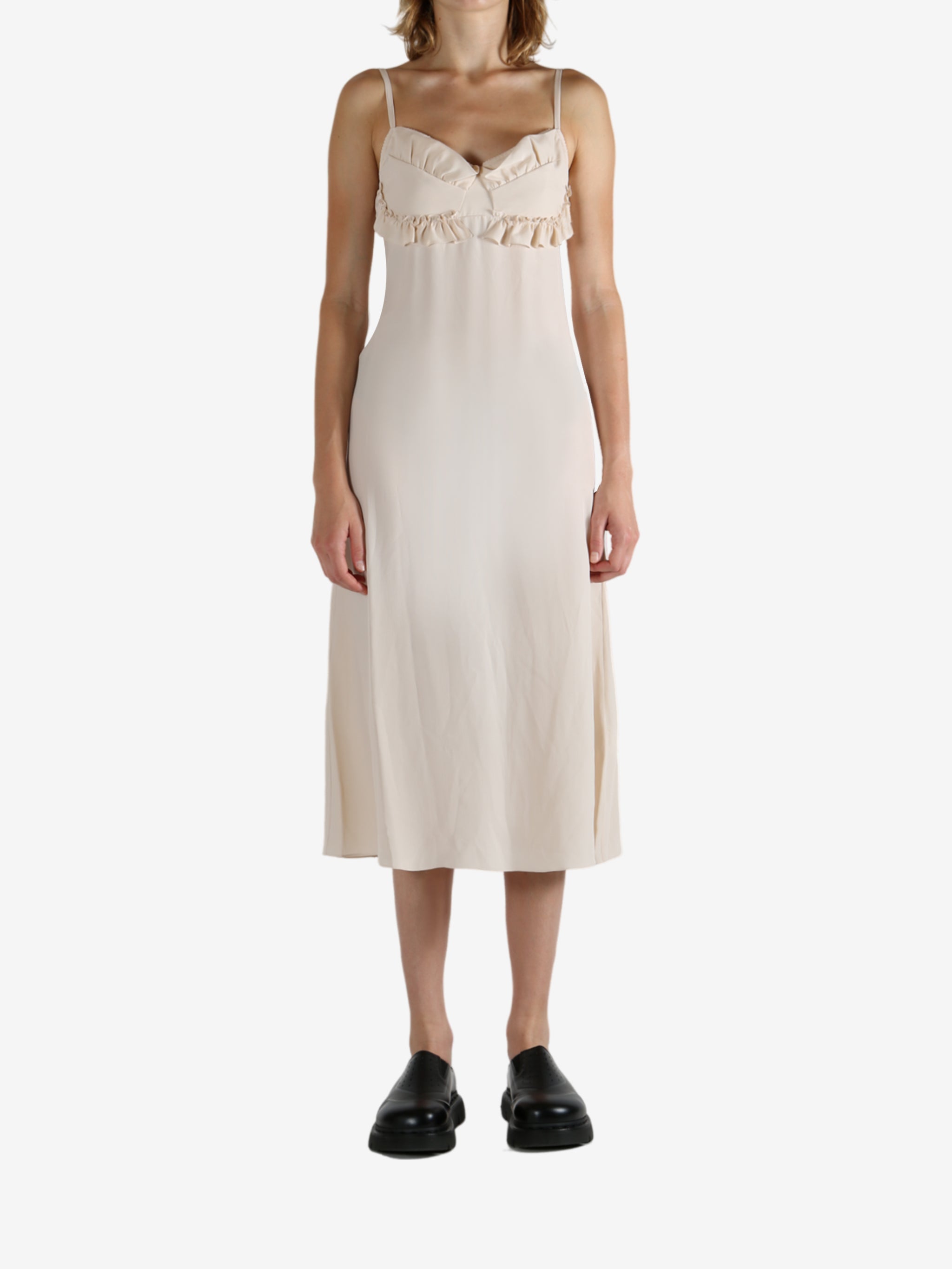 White dress worn by a person, showing the dress's fit