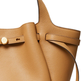 close up of brown bags, showing texture of the calf leather fabric