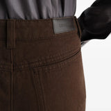 Brown pants worn by a person, showing the pants fit