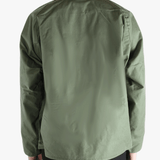 Green jacket worn by a person, showing the jacket fit