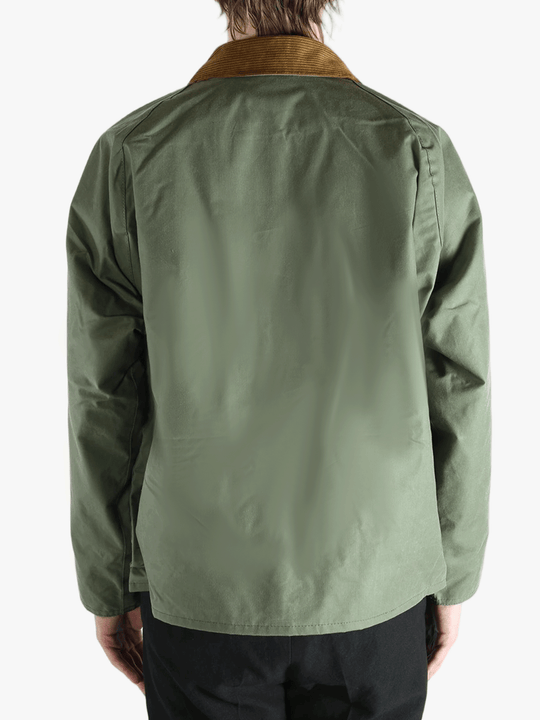 Green jacket worn by a person, showing the jacket fit
