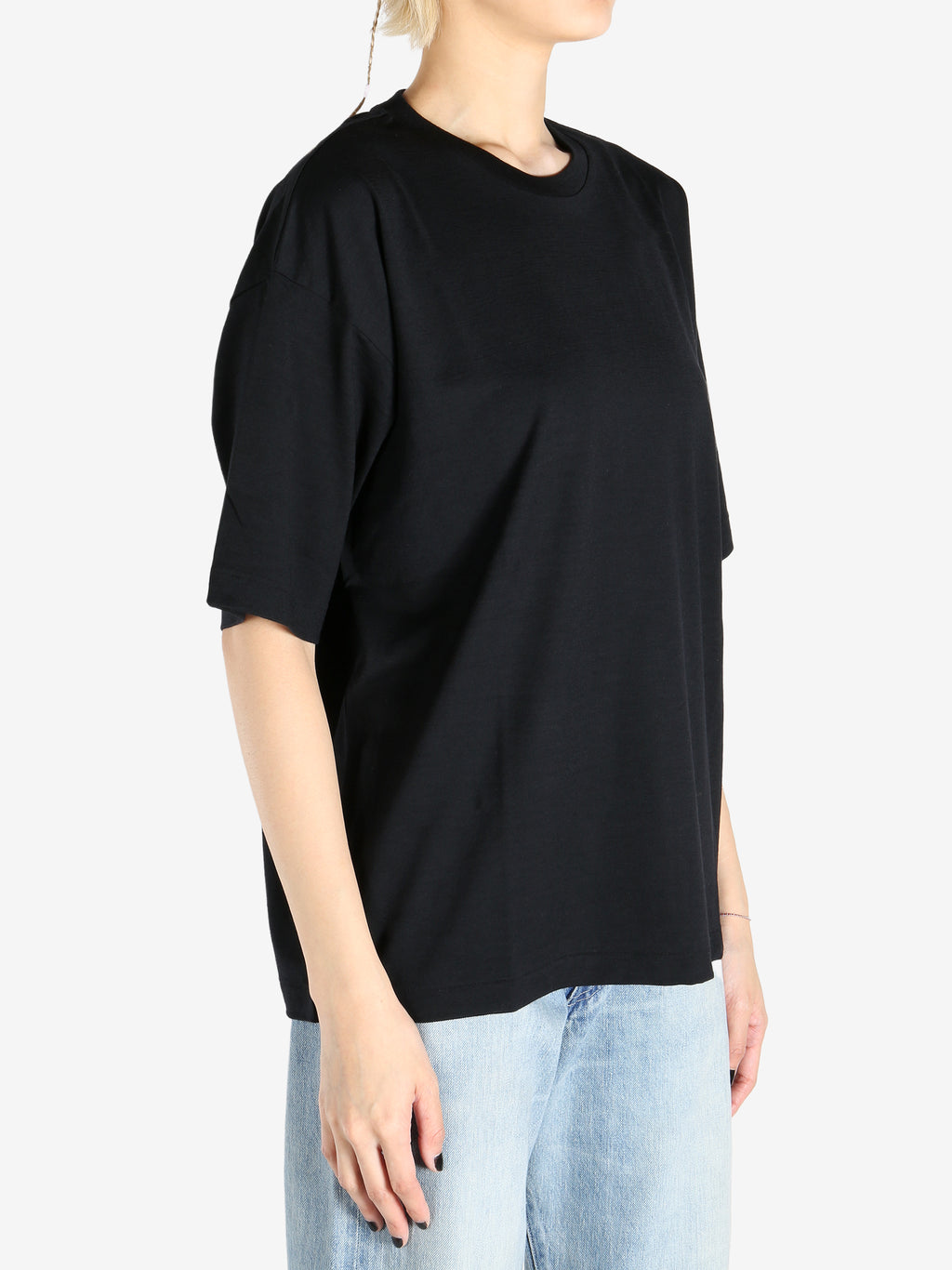 Black T-shirt worn by a person, showing the shirt's fit