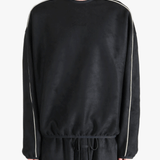 Black shirt worn by a person, showing the shirt's fit