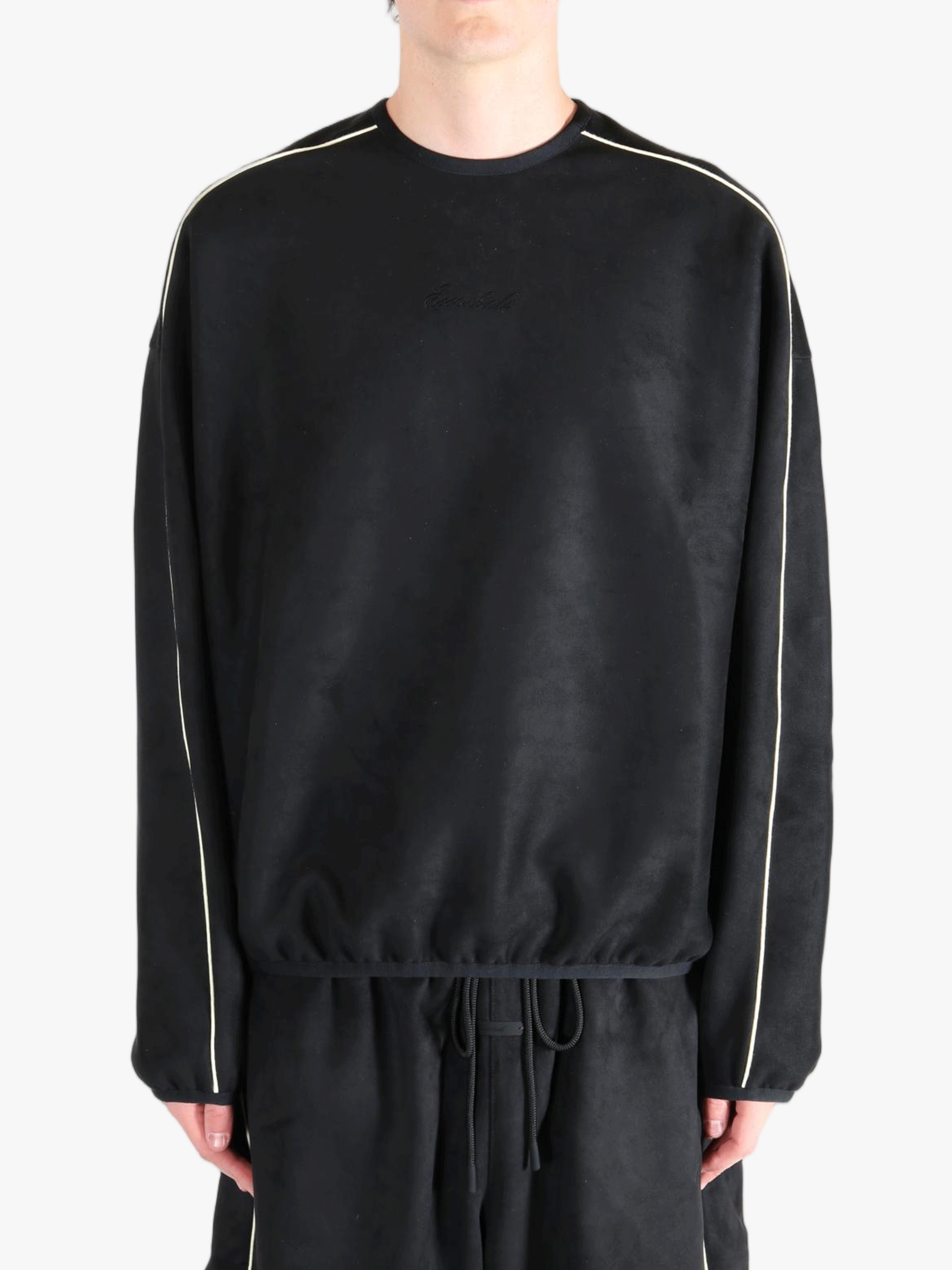 Black shirt worn by a person, showing the shirt's fit