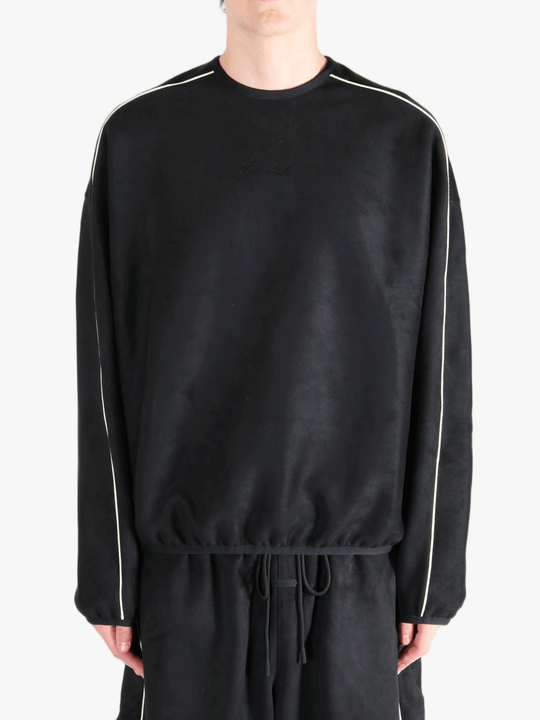 Black shirt worn by a person, showing the shirt's fit