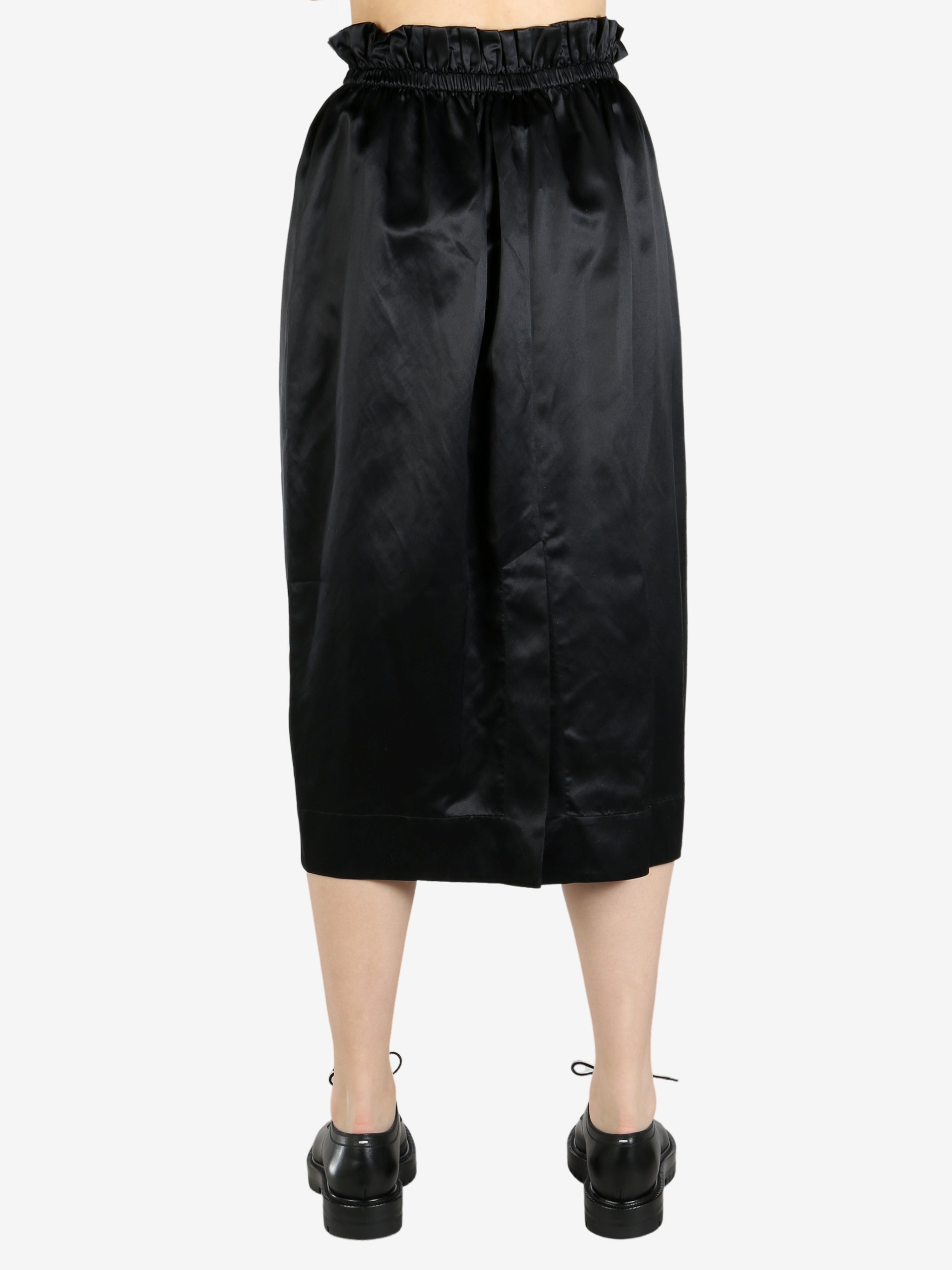 black skirt worn by a person, showing the skirt fit
