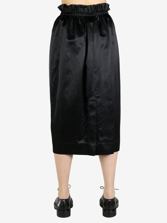 black skirt worn by a person, showing the skirt fit
