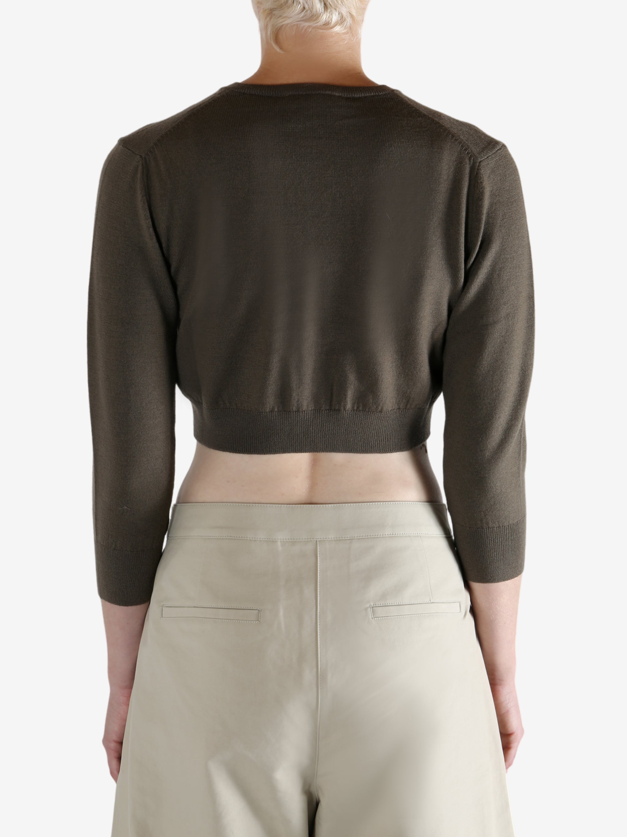 Brown cardigan worn by a person, showing the cardigan's fit