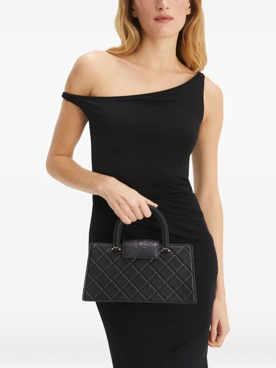 Black bag carried by a person, showing the bag’s fit