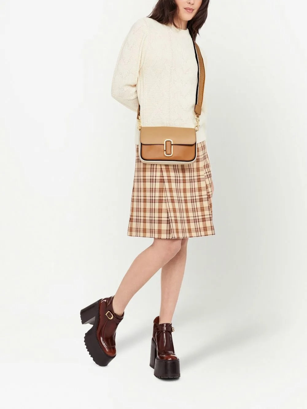 Tan bag carried by a person, showing the bag's fit