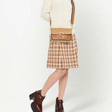 Tan bag carried by a person, showing the bag's fit