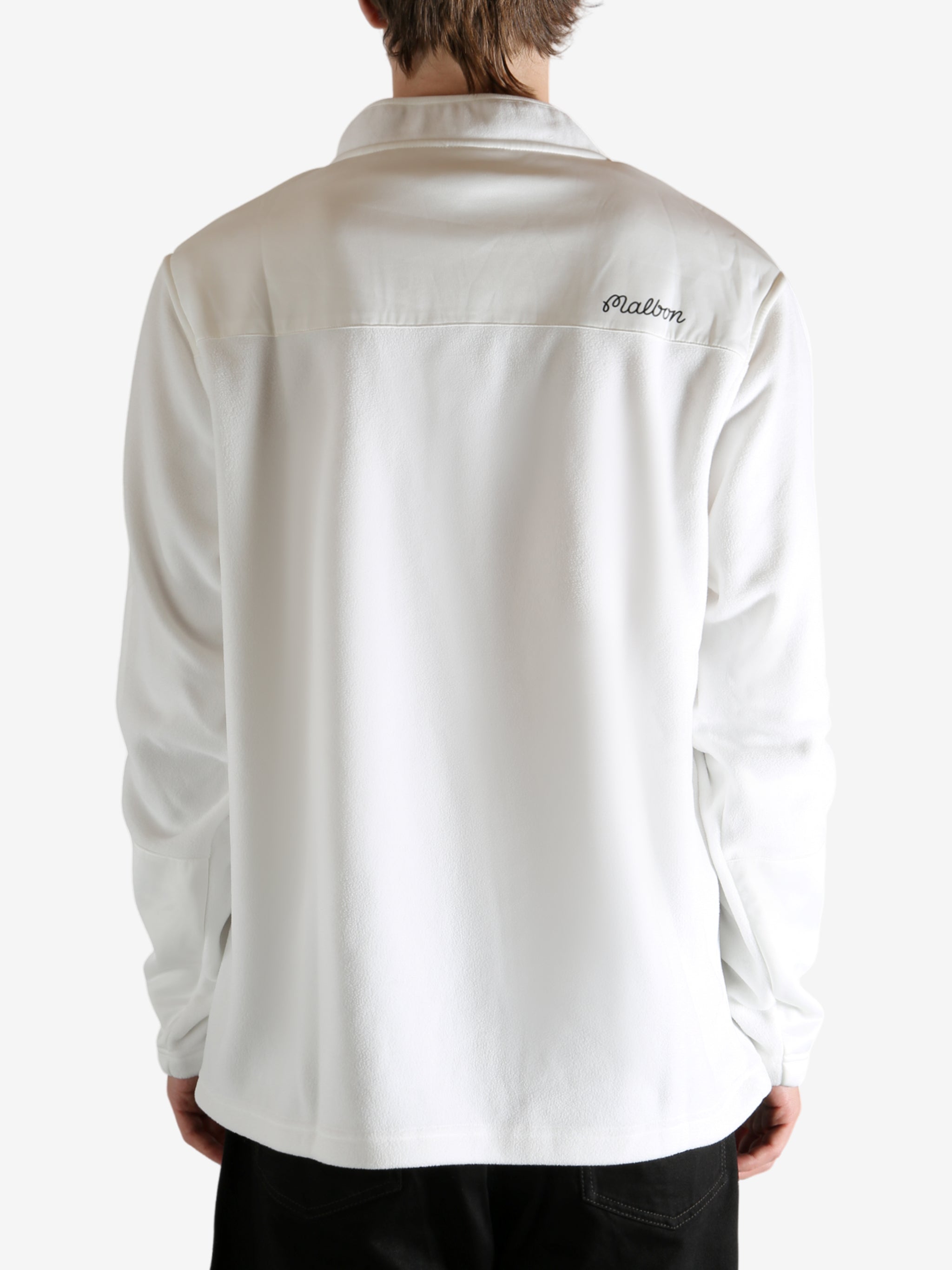 White sweatshirt worn by a person, showing the sweatshirt's fit