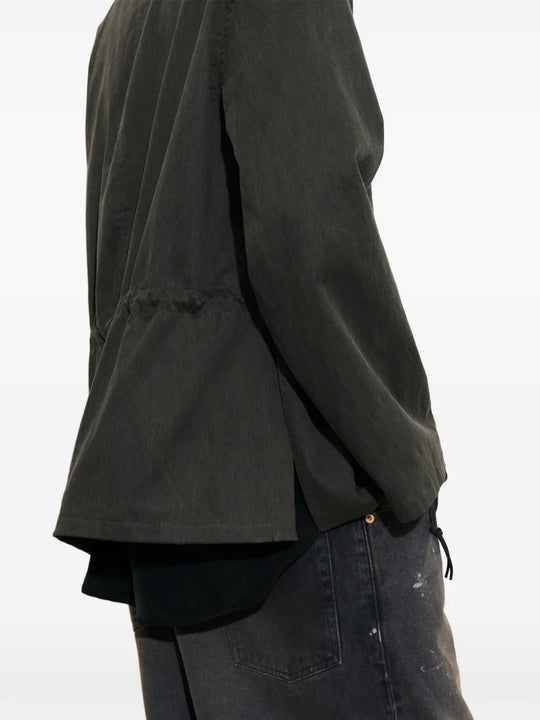 Close-up of green jacket, showing texture of the cotton fabirc