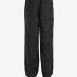 Black pant worn by a person, showing the pant’s fit