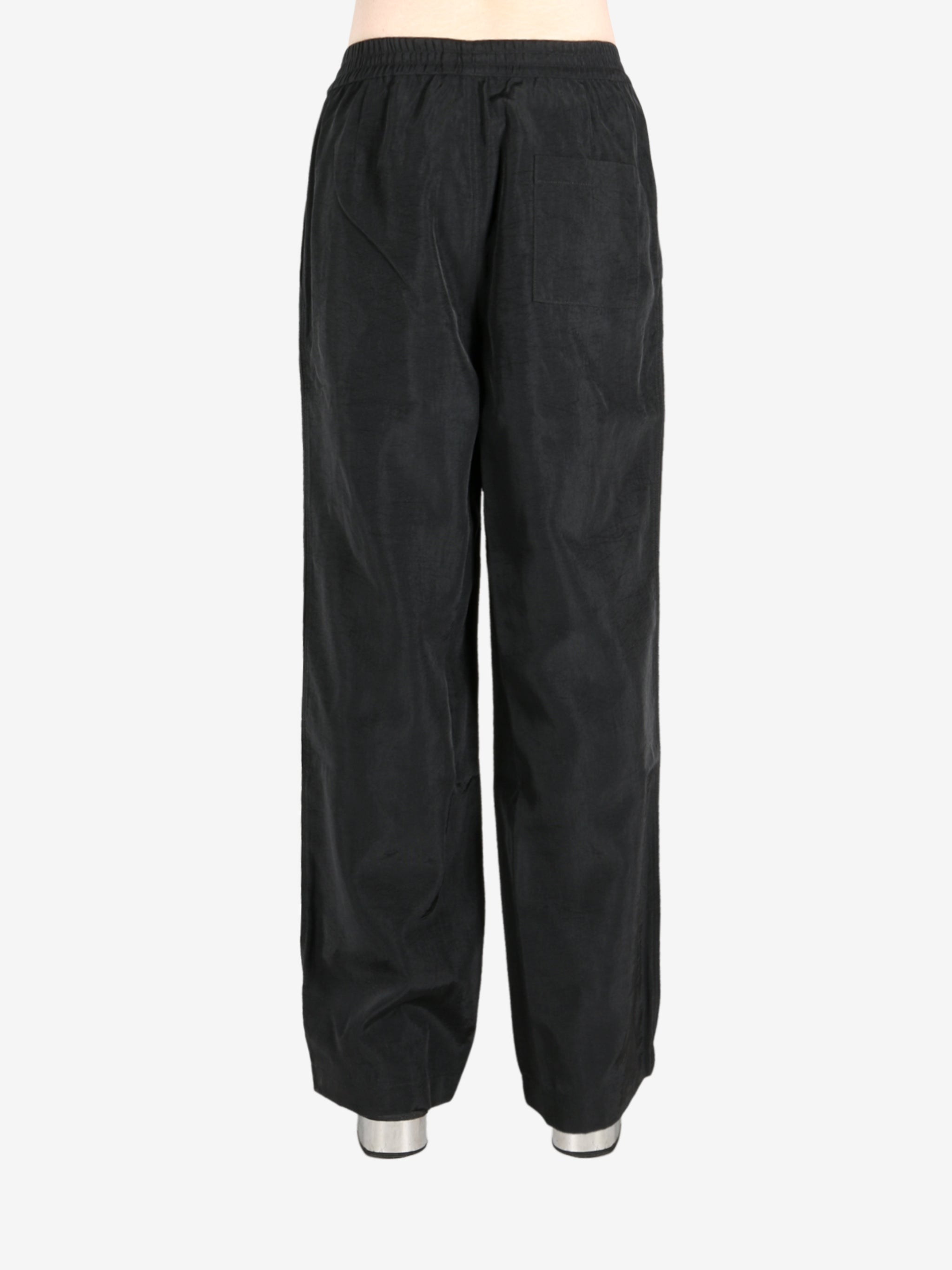 Black pant worn by a person, showing the pant’s fit