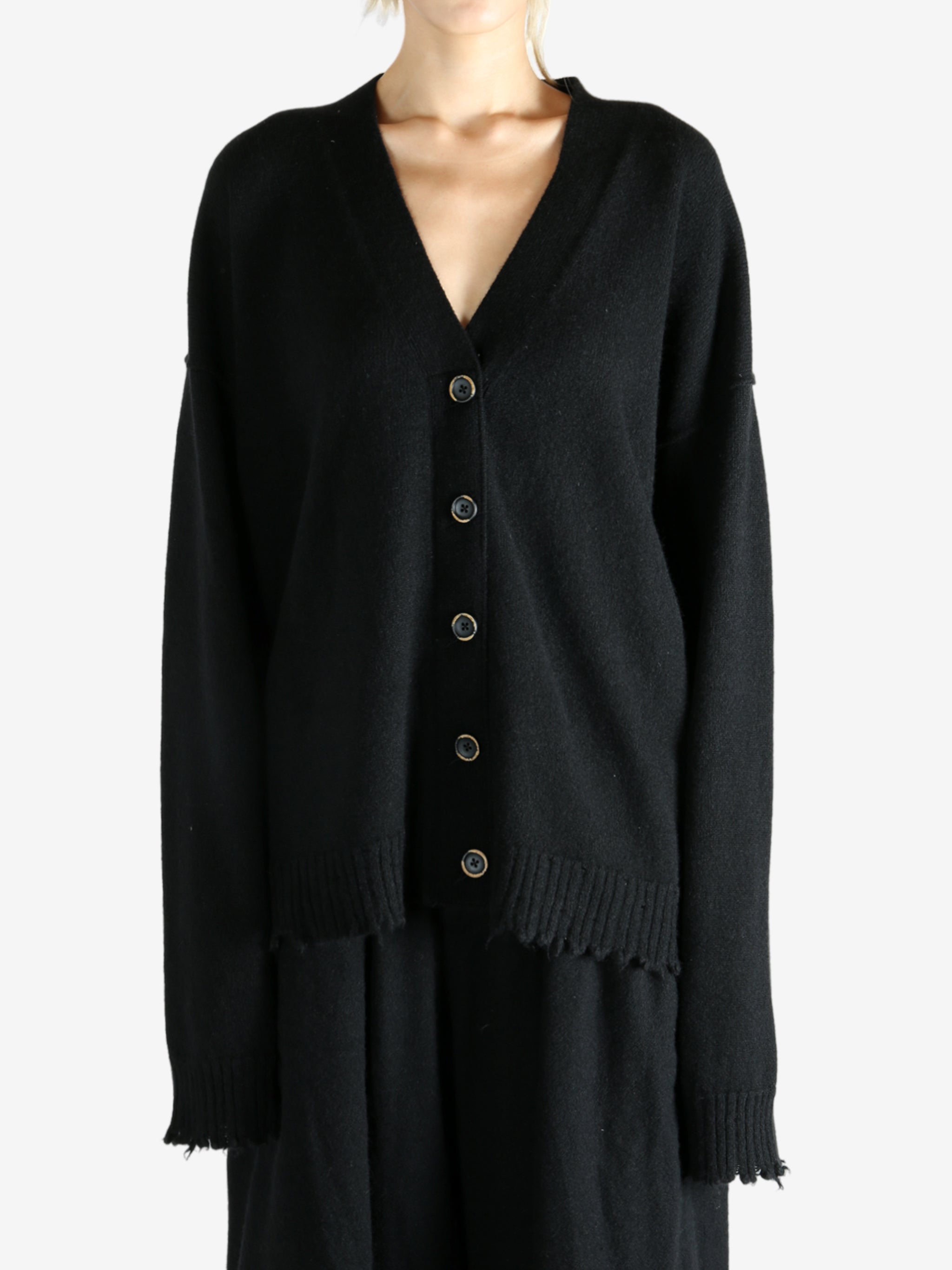 Black knitwear worn by a person, showing the knitwear's fit