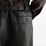Black pants worn by a person, showing the pants fit