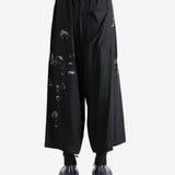 Black pants worn by a person, showing the pants fit