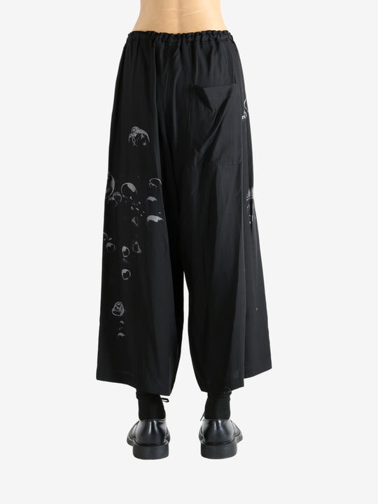 Black pants worn by a person, showing the pants fit