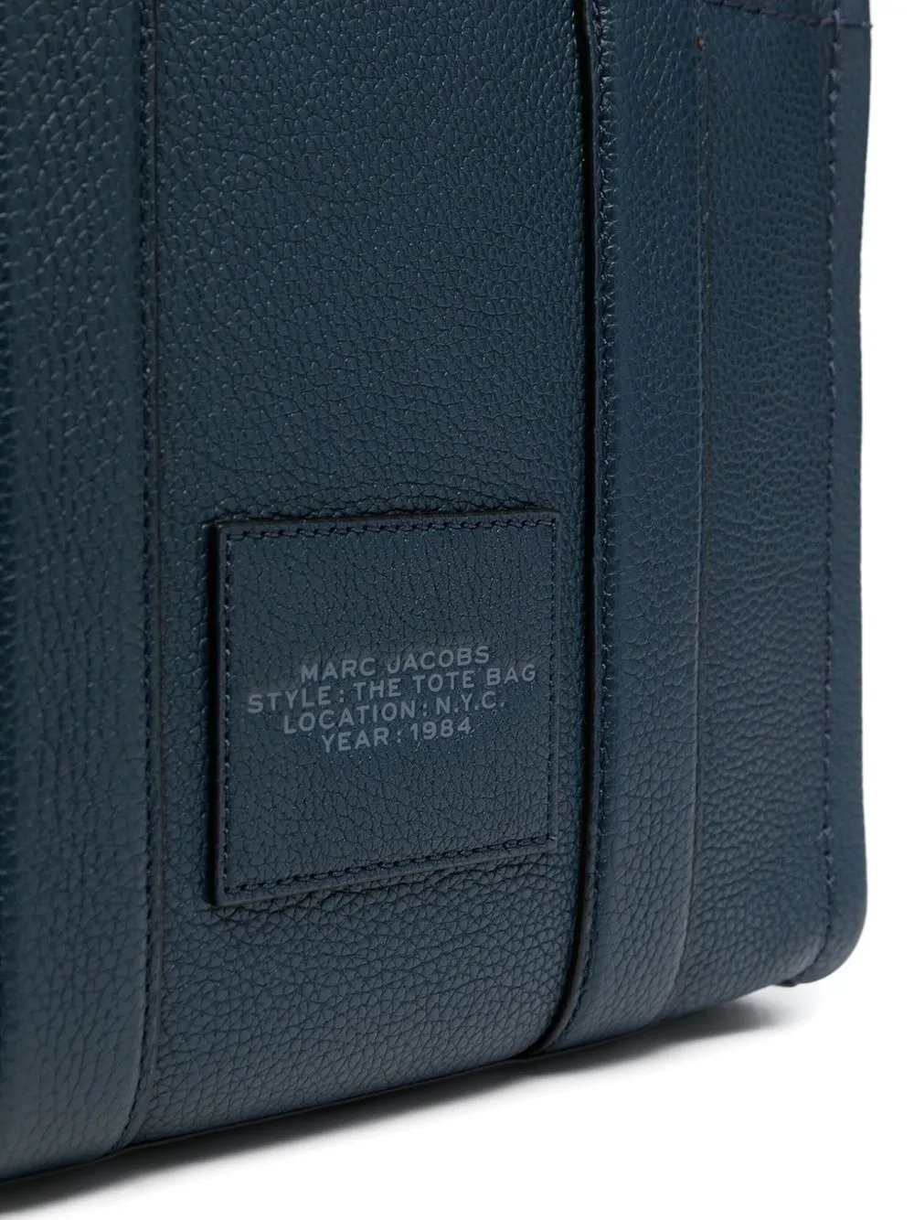 Close up of the blue bag, showing texture of the leather fabric