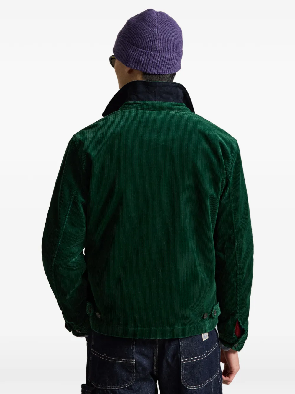 Green windbreaker worn by a person, showing the windbreaker's fit