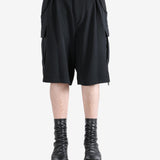 Black pants worn by a person, showing the pants's fit