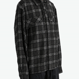Black shirt worn by a person, showing the shirt fit