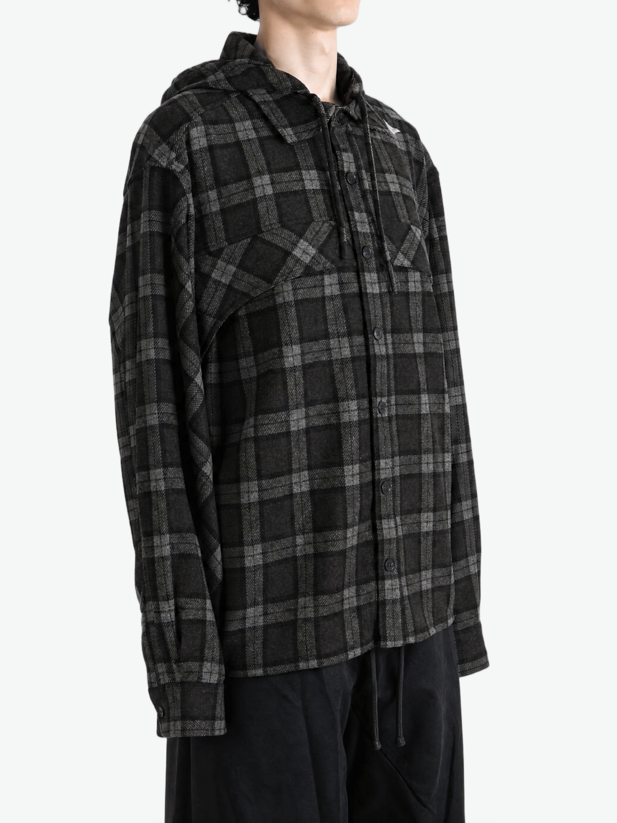 Black shirt worn by a person, showing the shirt fit
