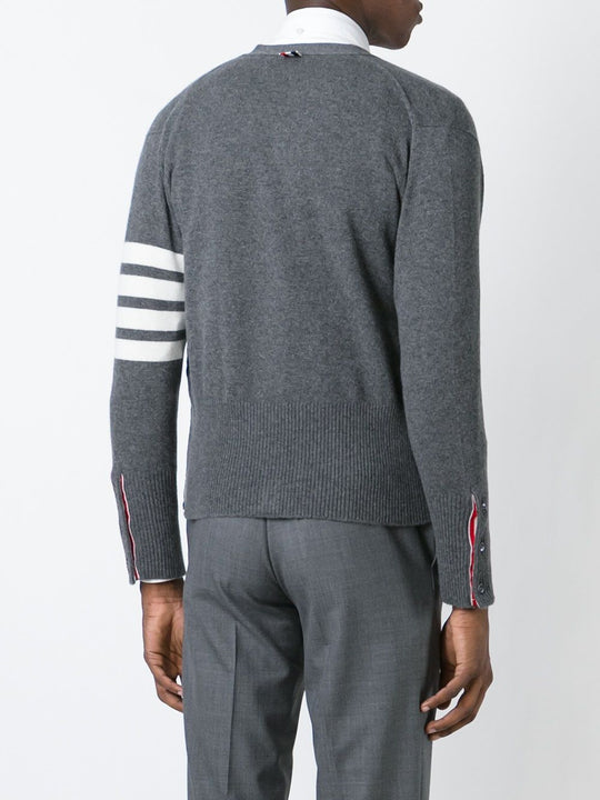Grey knitwear worn by a person, showing the knitwear’s fit