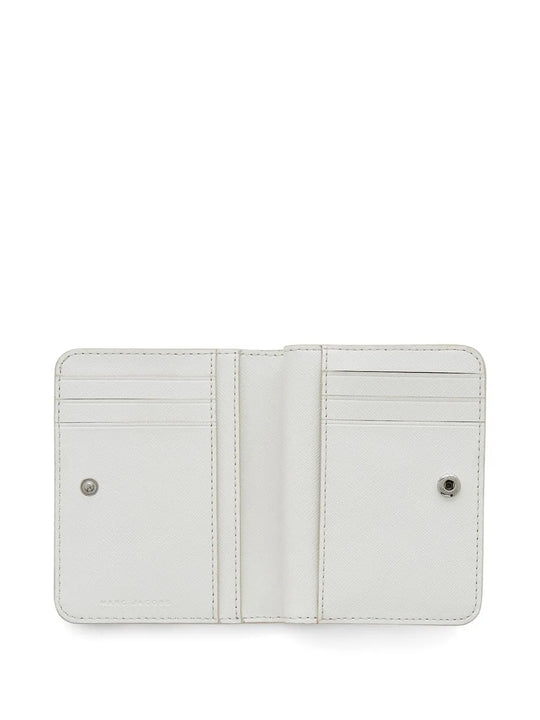 Close up of white wallet, showing texture of the split cow leather and polyurethane fabric